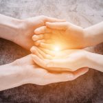 Light in young family hands offering